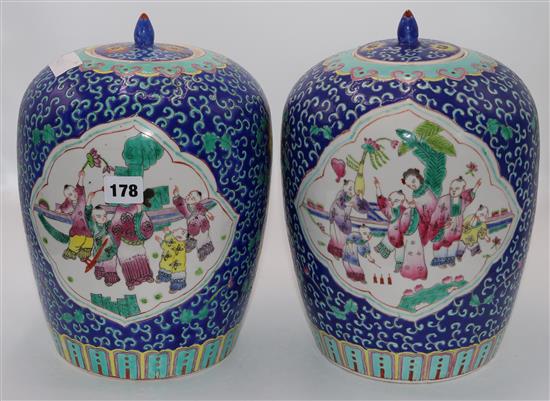 A pair of Chinese famille jars and covers